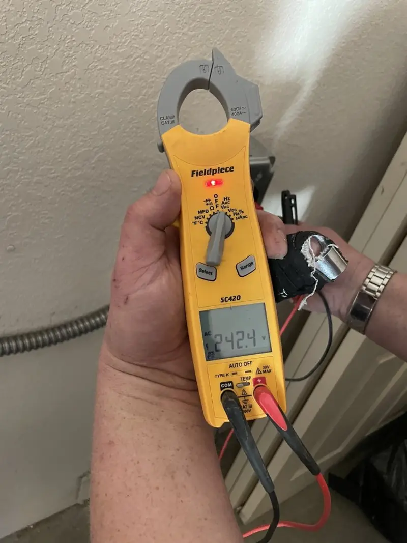 Voltage testing with clamp meter during Electrical Installation Services in Manteno